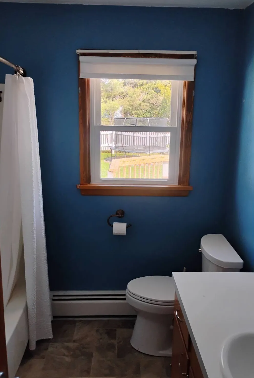 Same bathroom after, repainted a bold deep blue
