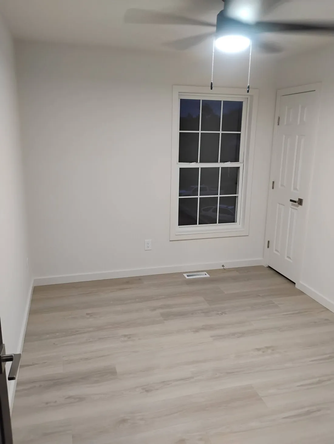 Same bedroom after, painted clean and bright with crisp trim