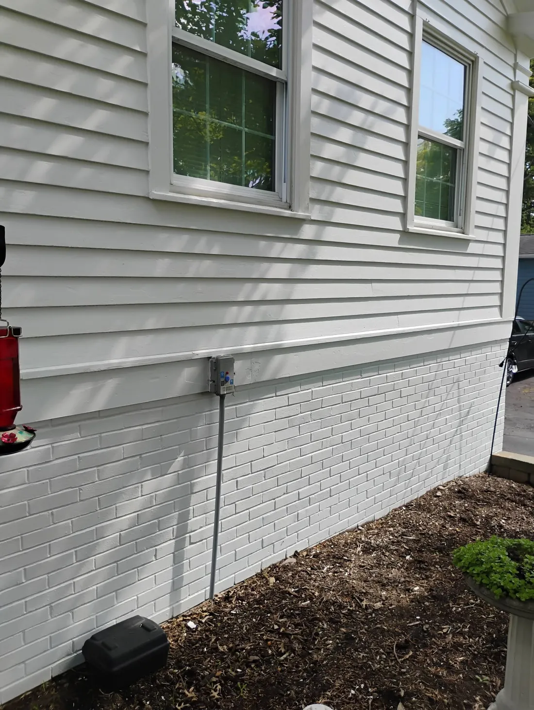 Commercial-grade exterior repaint with clean white siding and painted brick